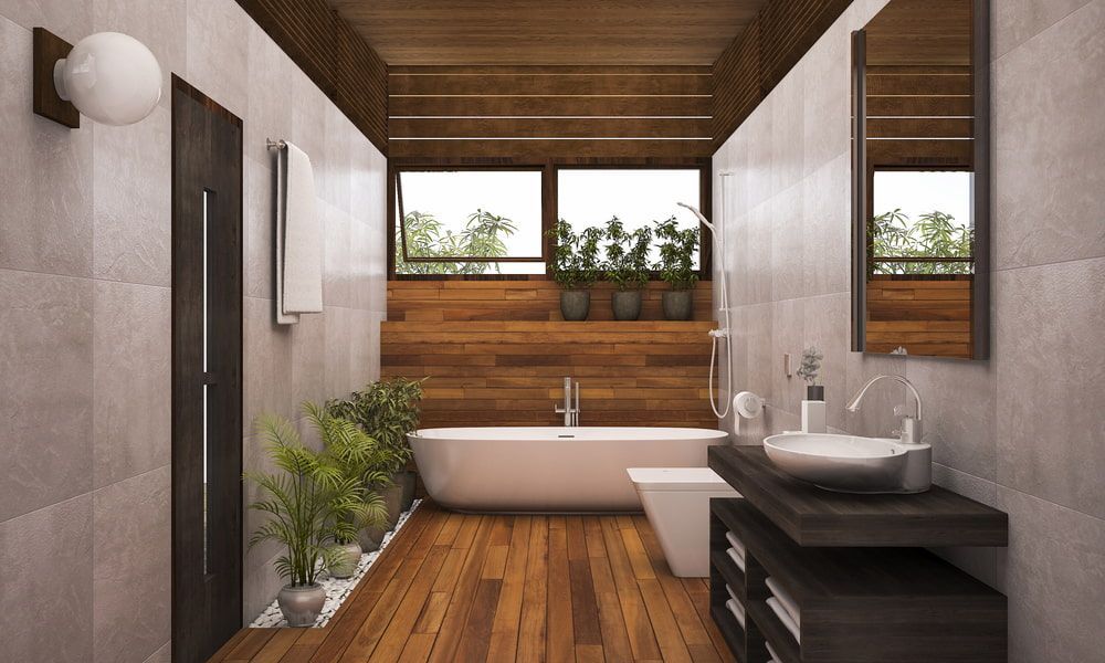 A Bathroom with a Tub, Sink, Plant and Mirror — Junction Hill Nursery in Junction Hill, NSW