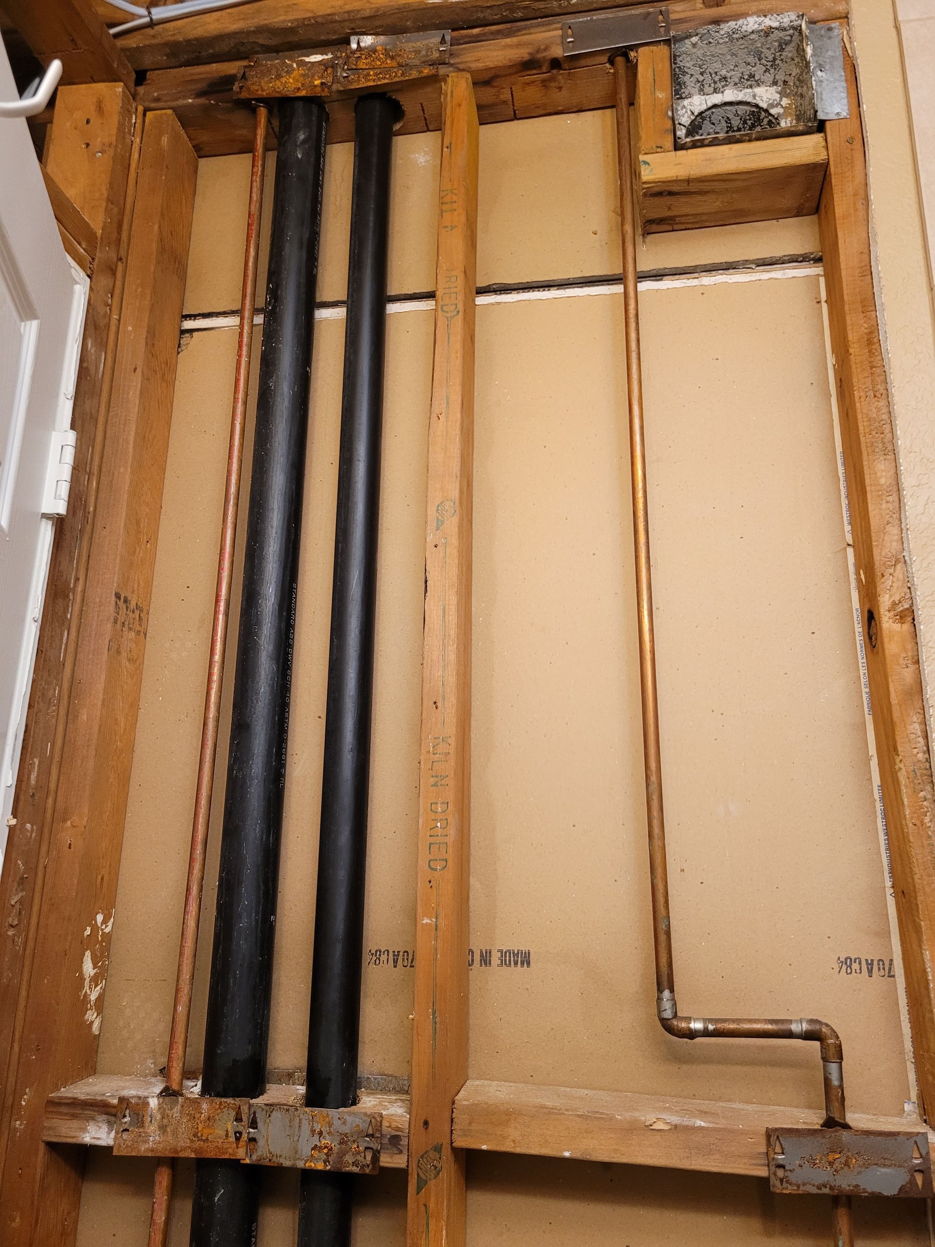 A wooden frame with pipes coming out of it