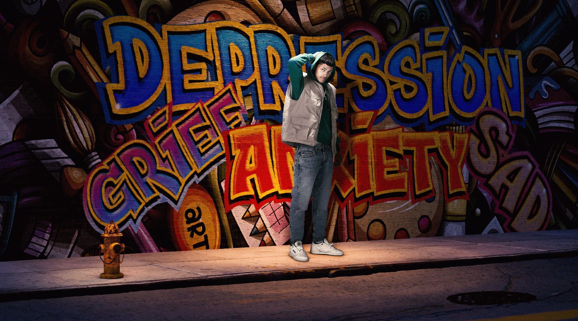 teen boy stands in front of wall tagged with