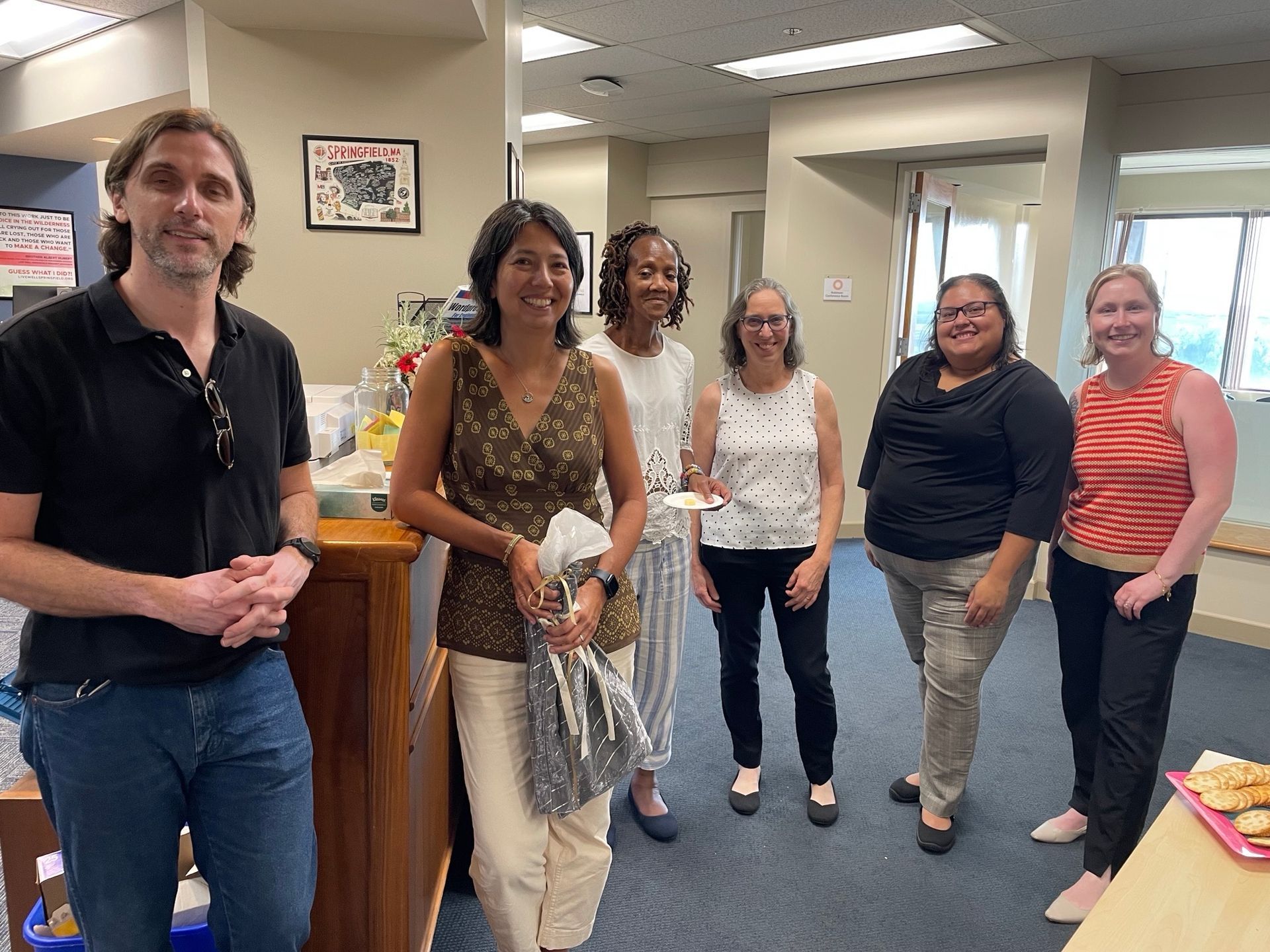 Kathleen Szegda surrounded by colleagues