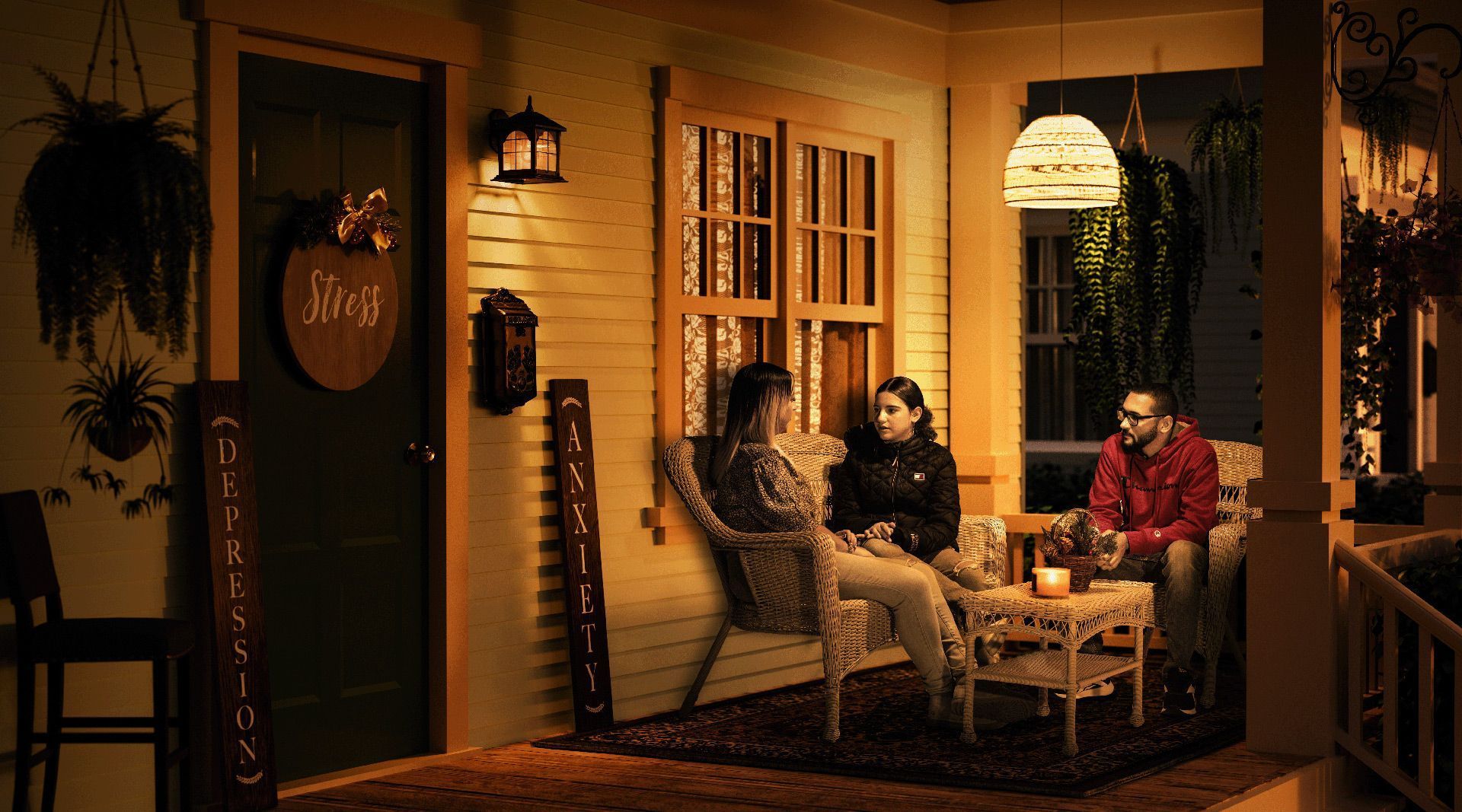 Teen sits on porch with mother and father