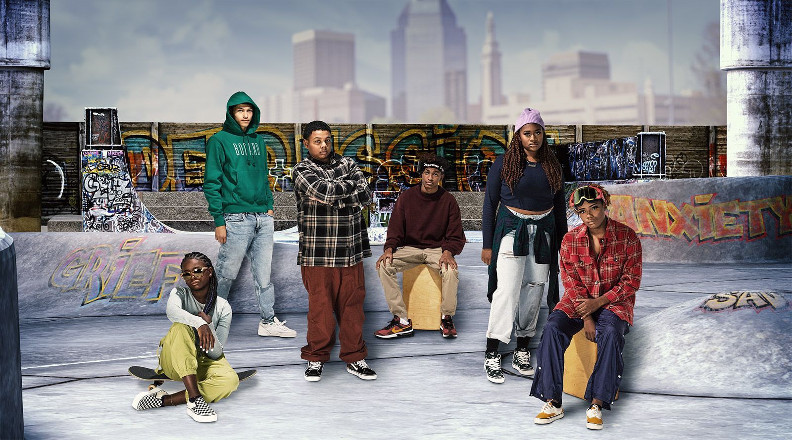 Group of teens gather at skatepark with Springfield skyline in the background