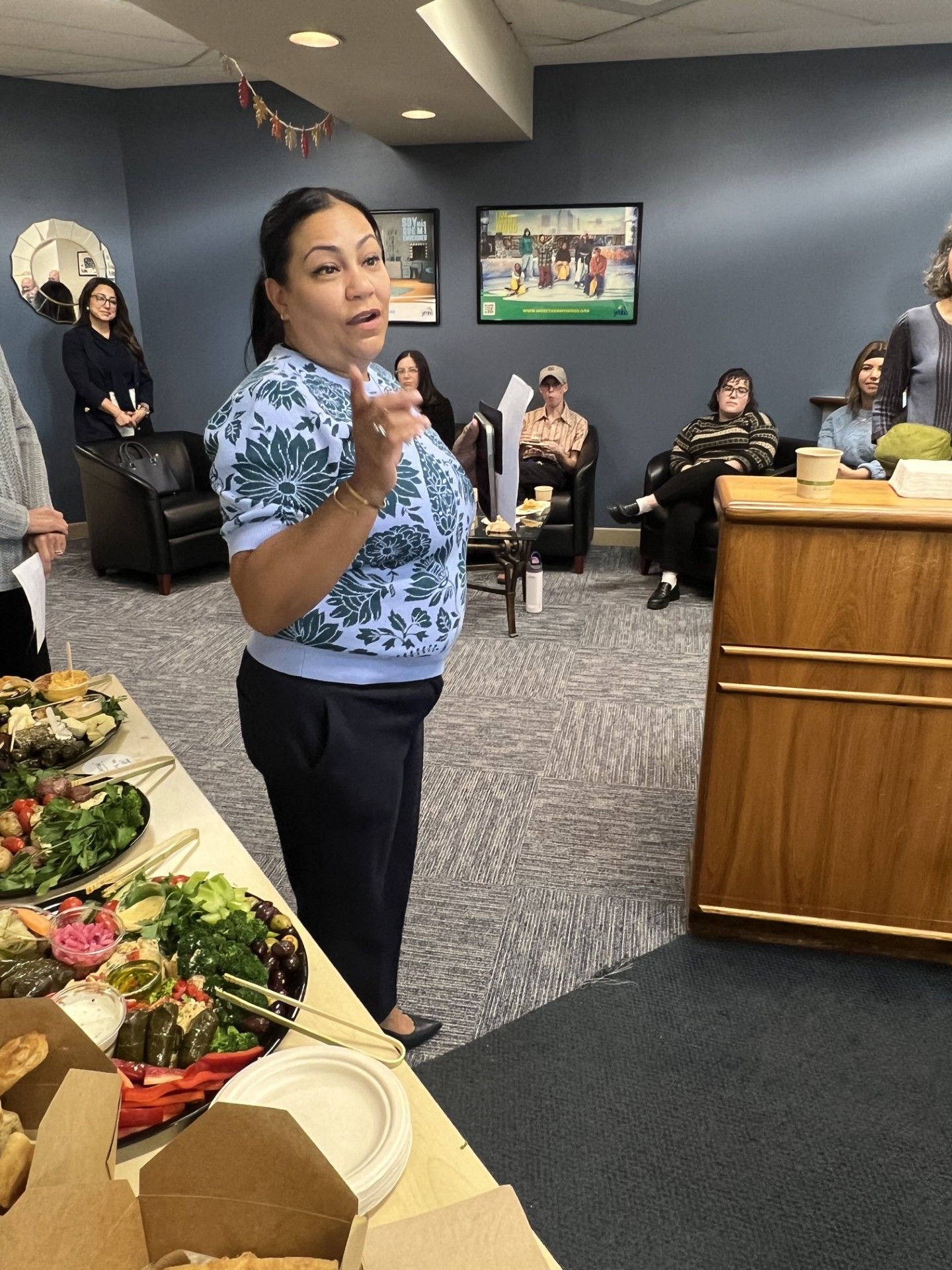 Luz Lopez speaking next to table with food