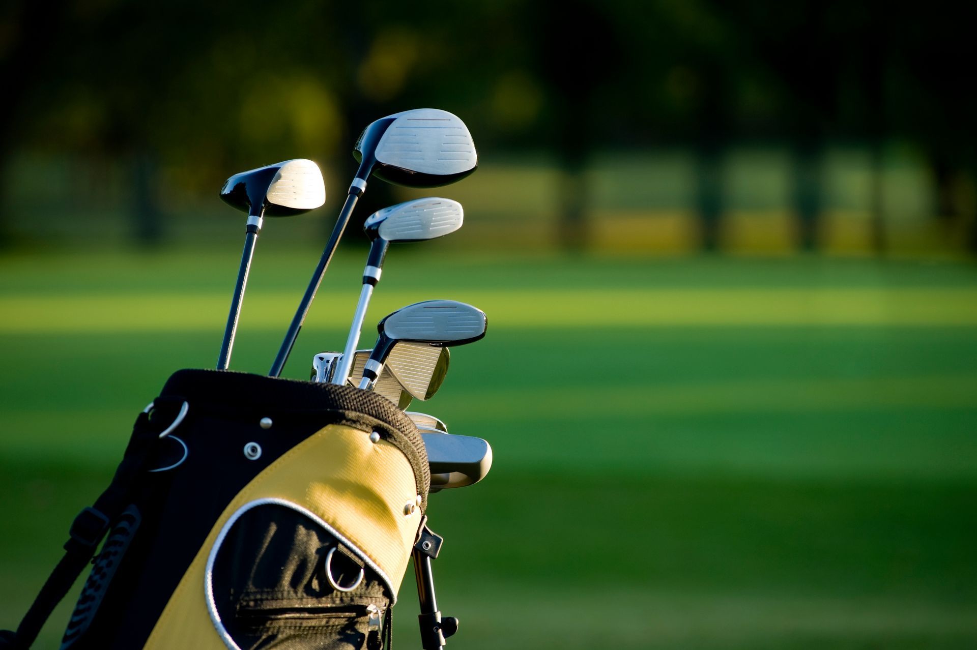 A golf bag filled with golf clubs on a golf course
