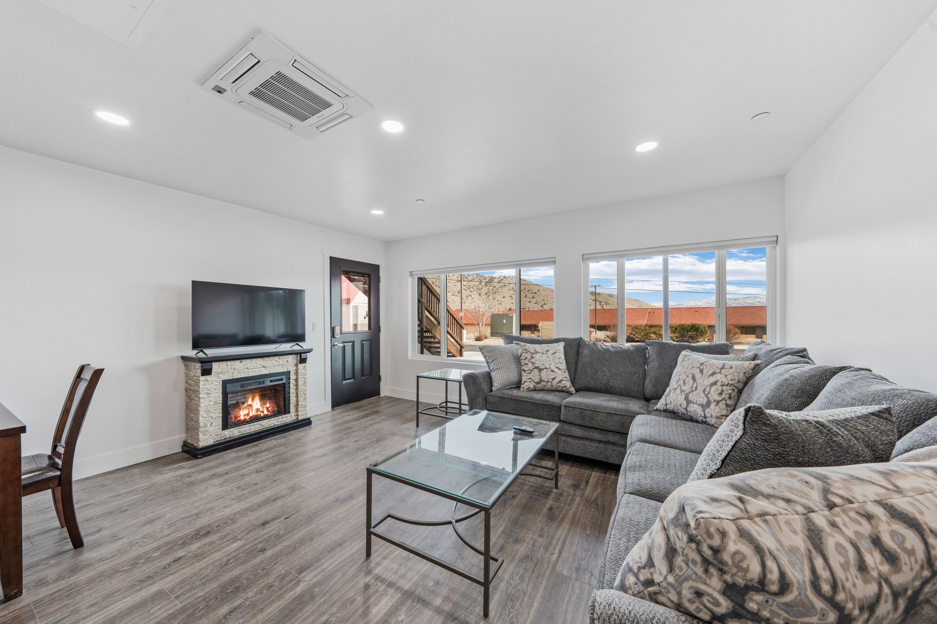 A living room with a couch , fireplace and television.