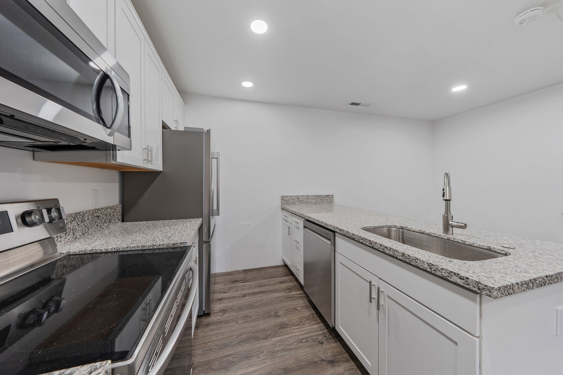 A kitchen with stainless steel appliances and granite counter tops
