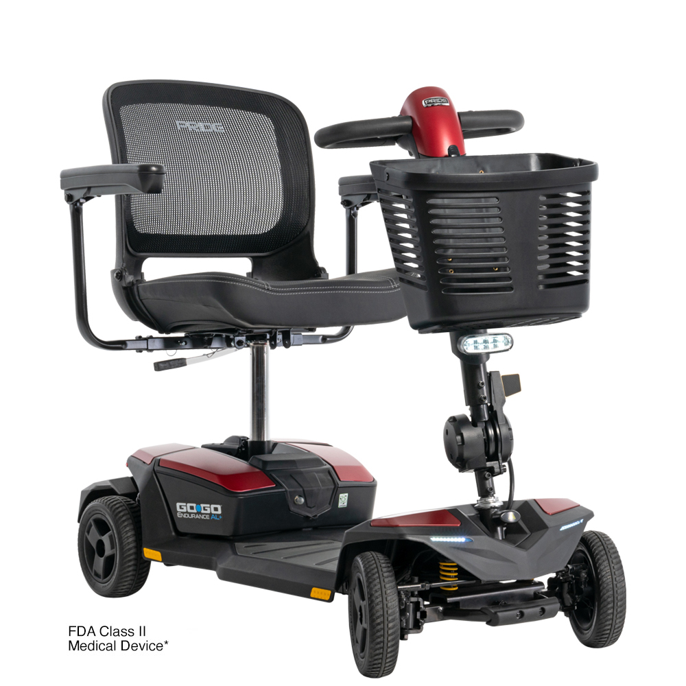Red and black Go-Go mobility scooter with mesh seat, basket, and armrests. FDA Class II Medical Device.
