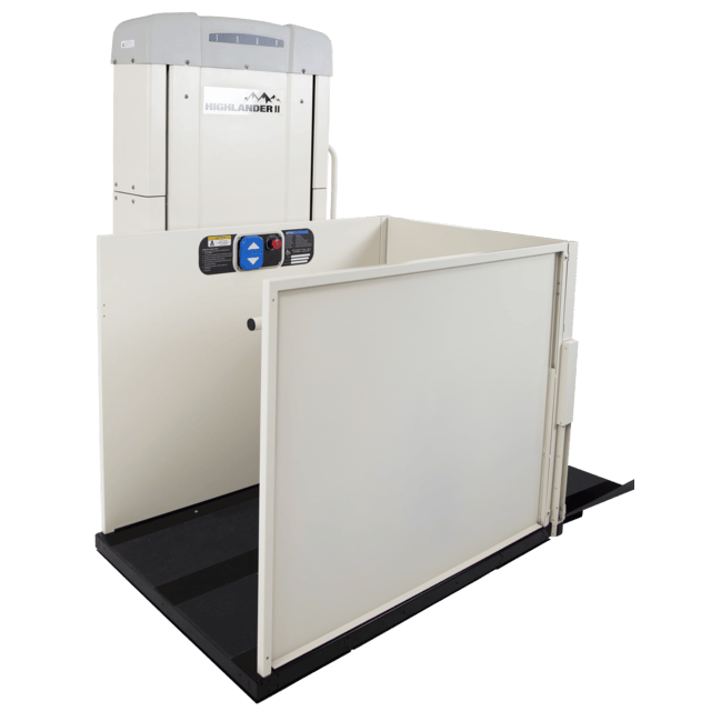 Cream-colored vertical platform lift with controls, open platform, and black base.