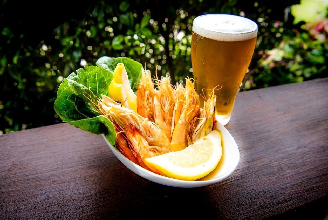 Fried Shrimp With Lemon and Beer on a Wooden Table — Chefs2Go in Bundaberg, QLD