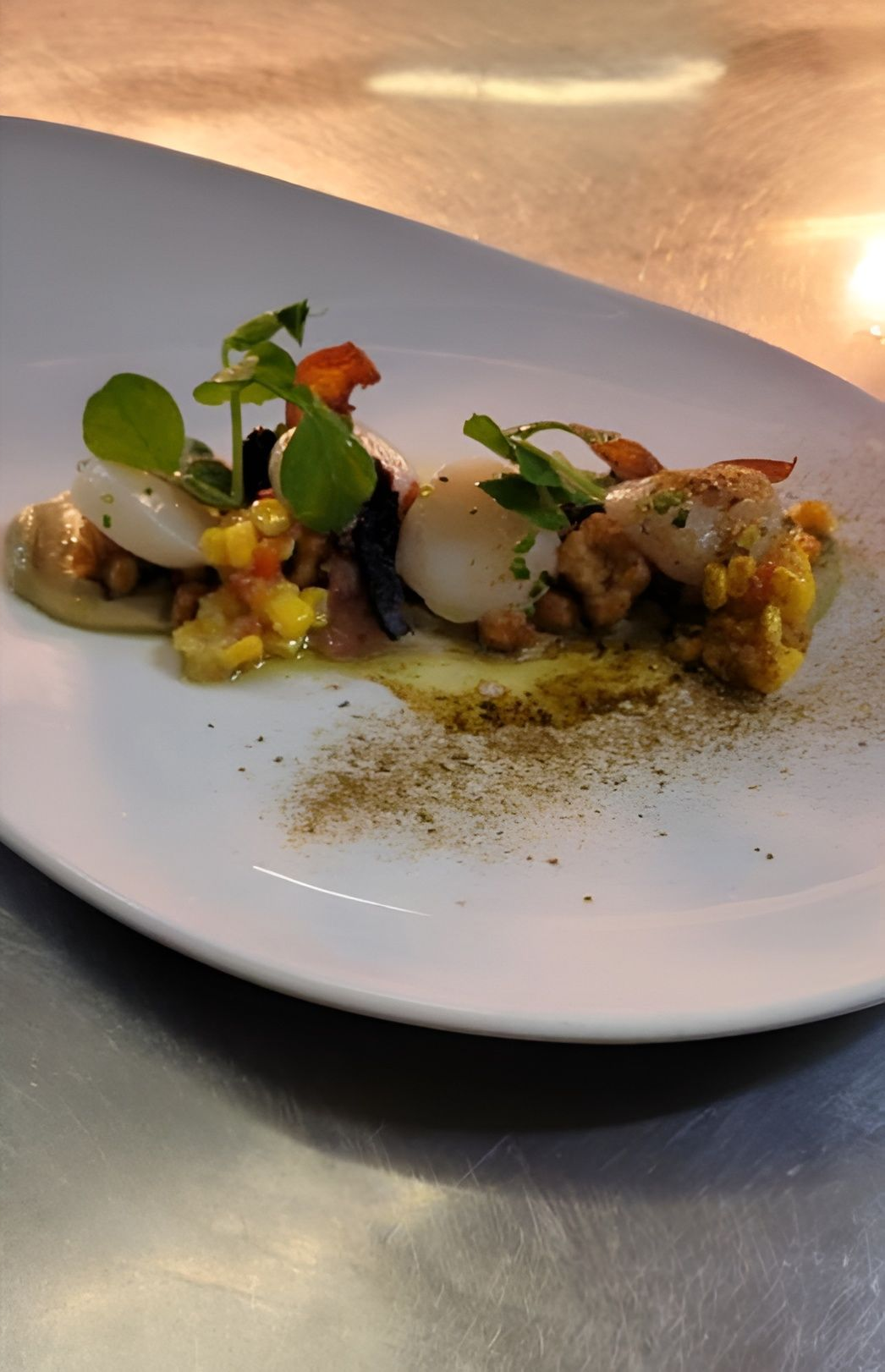 Seared Scallops on Corn, With Herbs and Sauce, on a White Plate, in a Kitchen Setting — Chefs2Go in Bundaberg, QLD