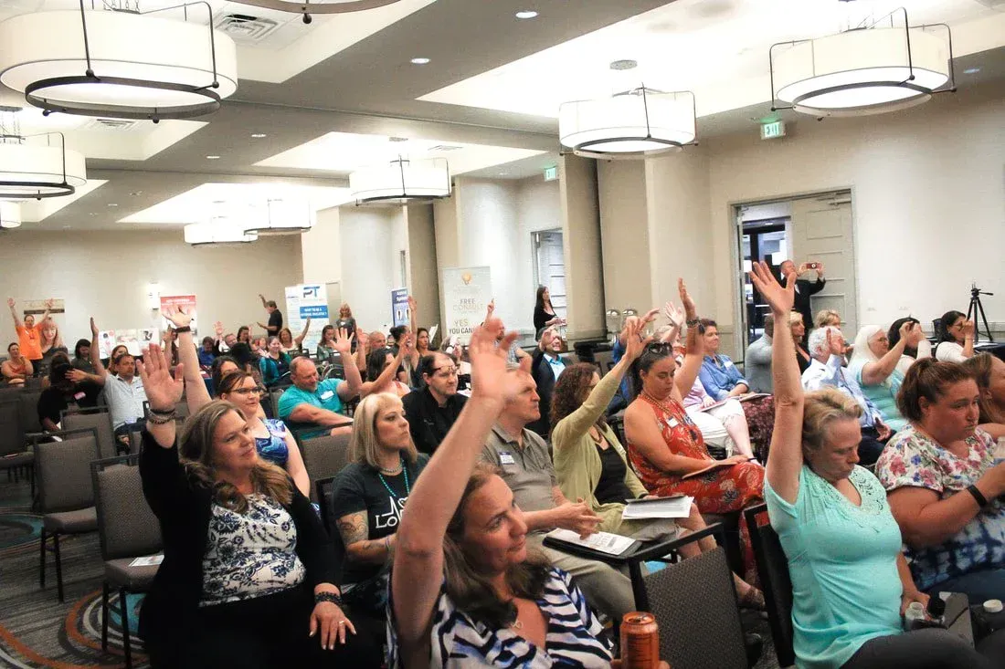 crowd raising hands