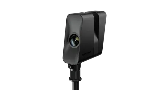 A black object is sitting on top of a pole on a white background.