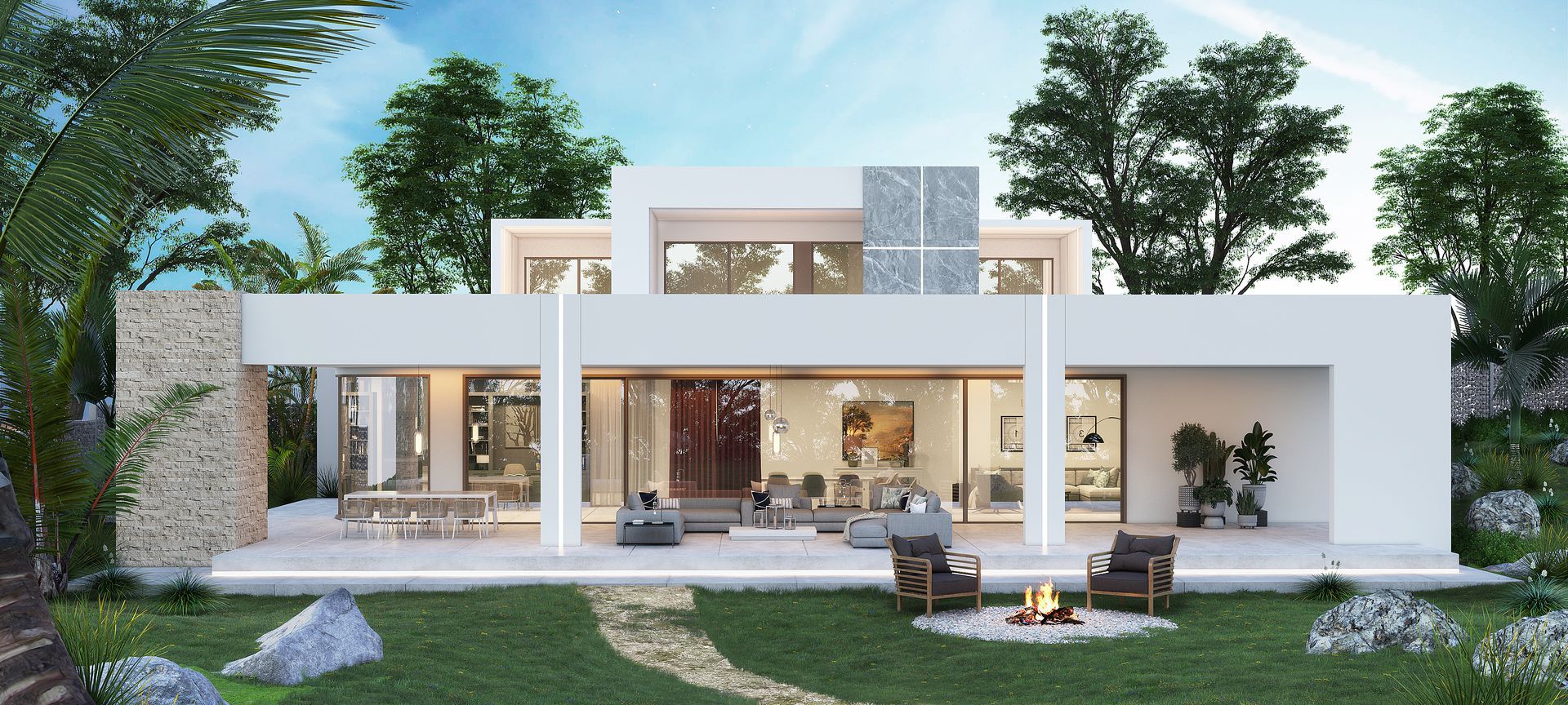 A large white house with a fire pit in front of it