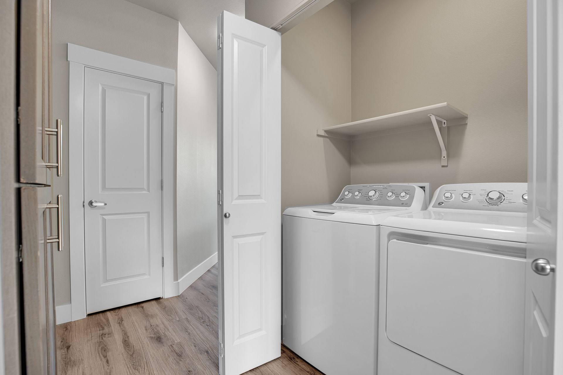 A laundry room with a washer and dryer in a house.