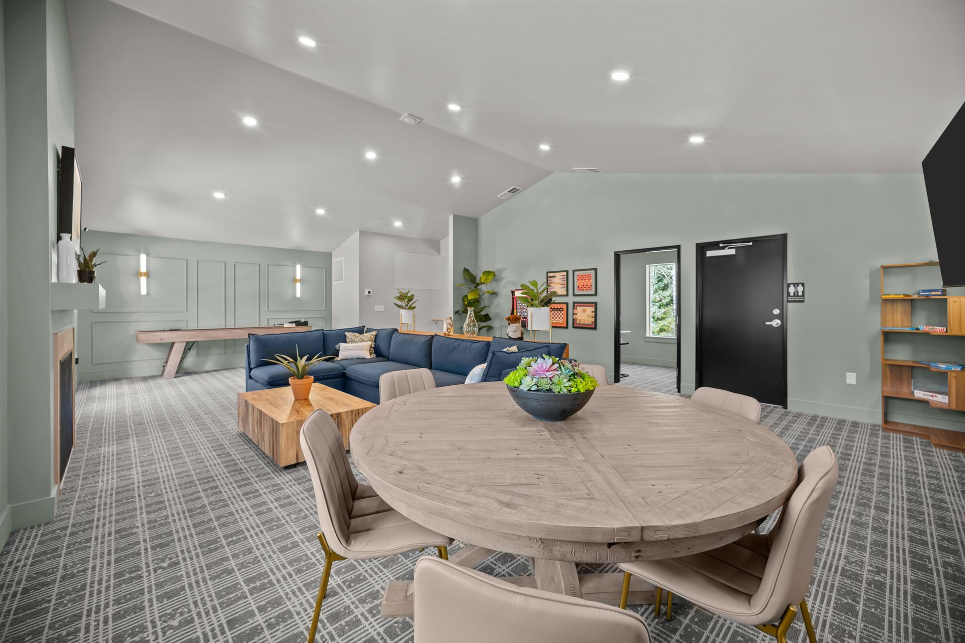 There is a table and chairs in the middle of the room.