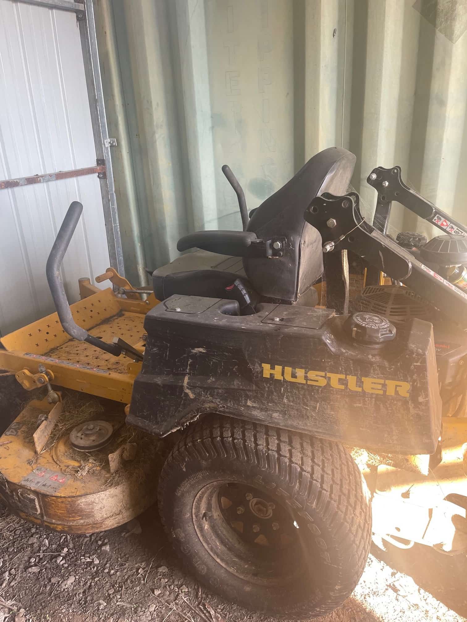 Yellow And Black Lawn Mower In A Shed — Mike's Tree Services In  Saint Georges Basin, NSW
