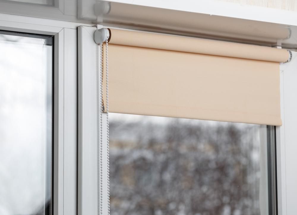 A Close Up of a Roller Blind on a Window — Design 2000 Blinds & Awnings In San Remo, NSW