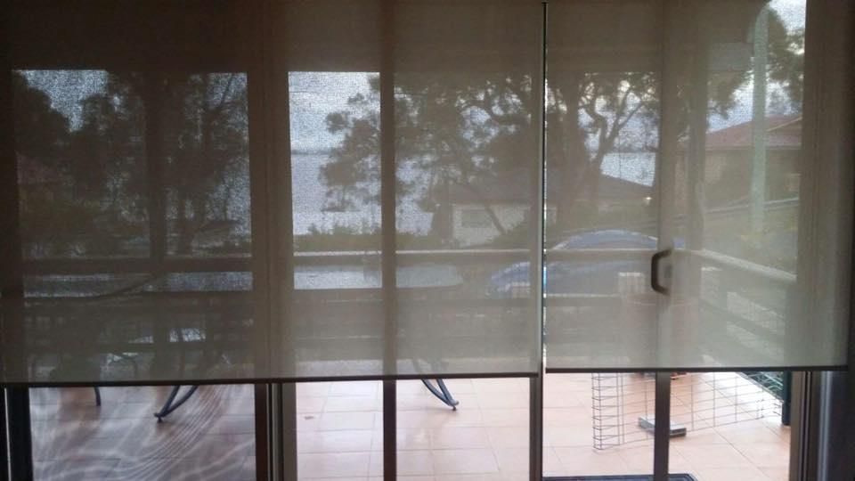 A Room With a Sliding Glass Door and Blinds on the Windows — Design 2000 Blinds & Awnings In San Remo, NSW