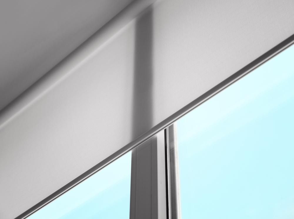 A Close Up of a Window With a Roller Blind on It — Design 2000 Blinds & Awnings In San Remo, NSW