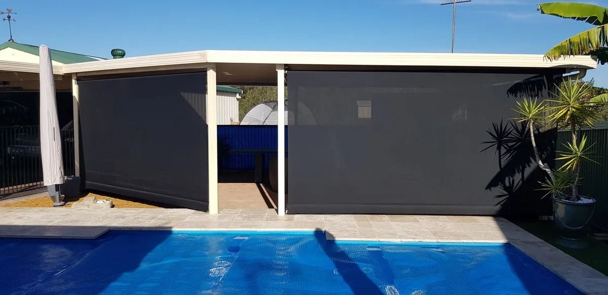 There is a Swimming Pool in the Backyard of a House — Design 2000 Blinds & Awnings In San Remo, NSW