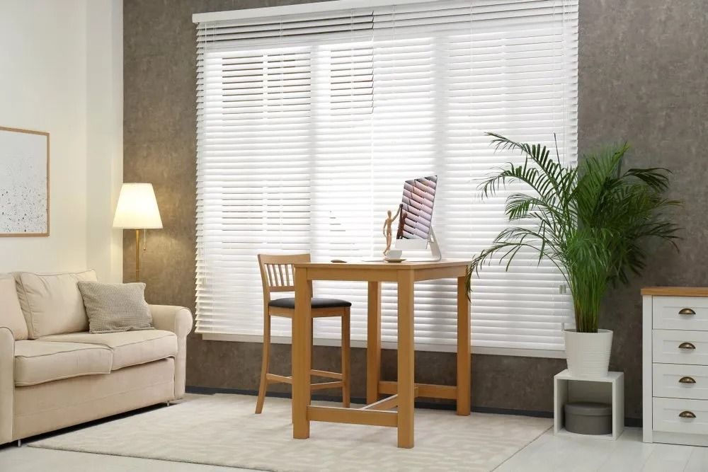 A Living Room With a Couch, Table, Chairs and a Window With Blinds — Design 2000 Blinds & Awnings In San Remo, NSW