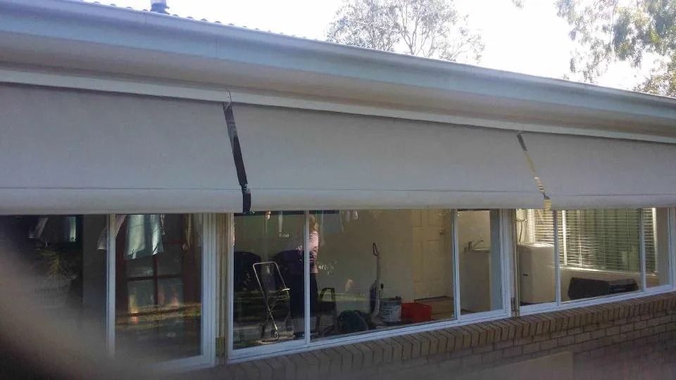 A House With a Lot of Windows and a White Awning on the Side of It — Design 2000 Blinds & Awnings In San Remo, NSW