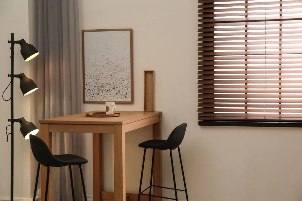 There is a Table and Chairs in the Room With Blinds on the Window — Design 2000 Blinds & Awnings In San Remo, NSW