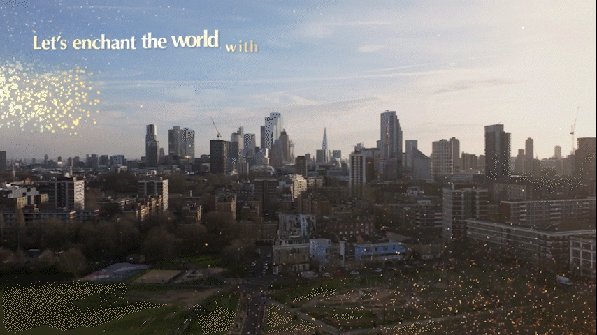 Sunlit city skyline at dusk with sparkles and the text “Let’s enchant the world.”