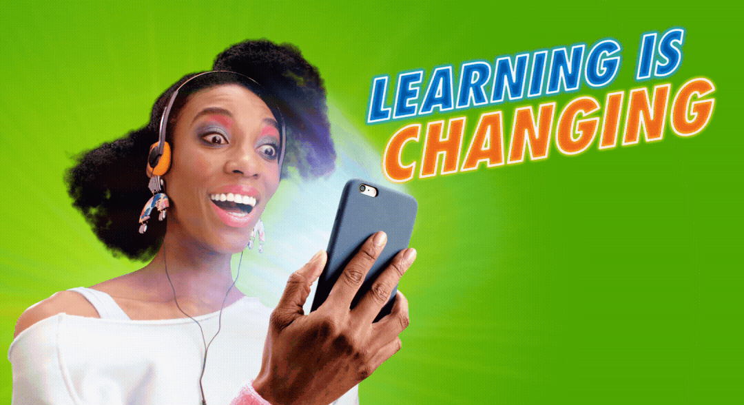 A woman wearing headphones is looking at her cell phone.
