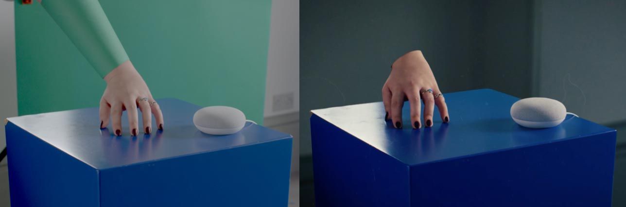 A woman 's hands are reaching out from a blue box.