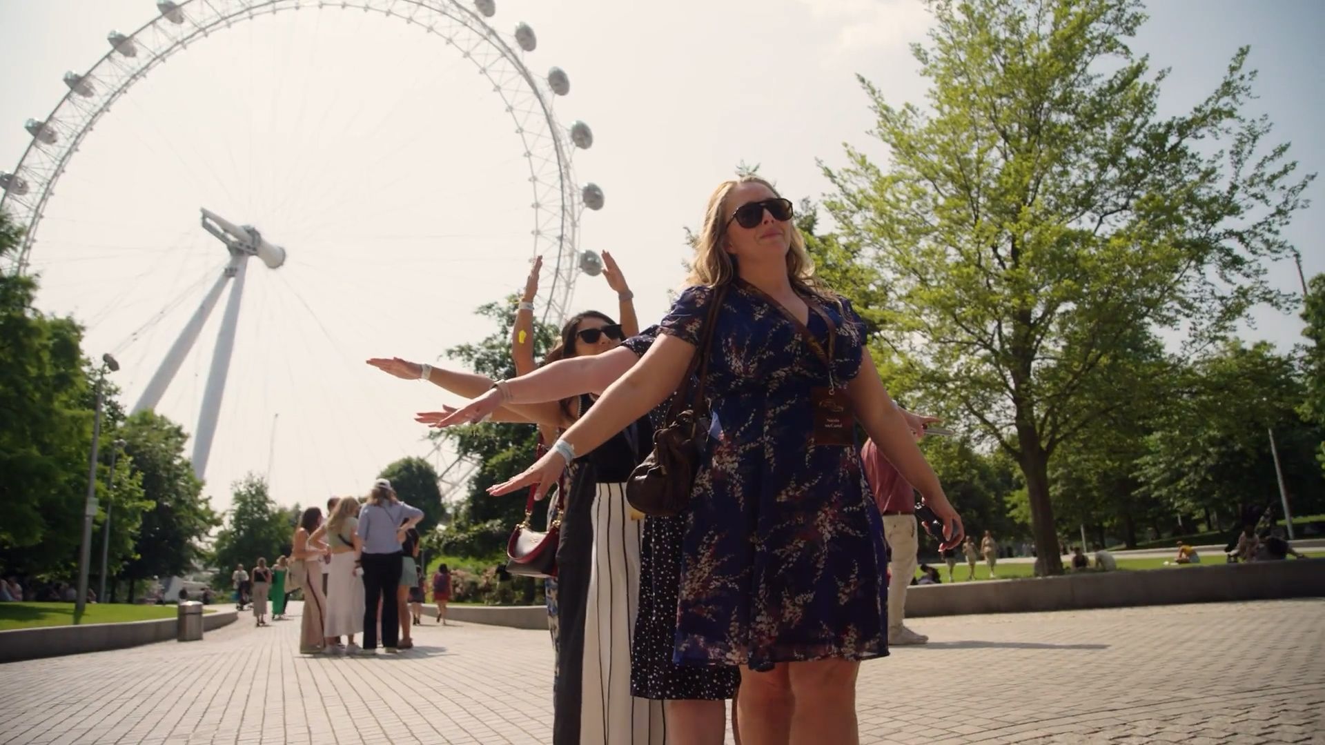 Woman posing in front of the London Eye on a sunny day