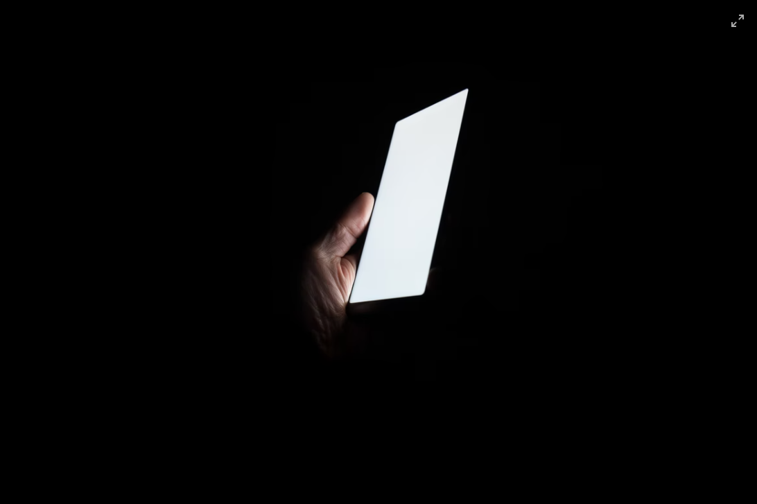 Phone flashing in darkness