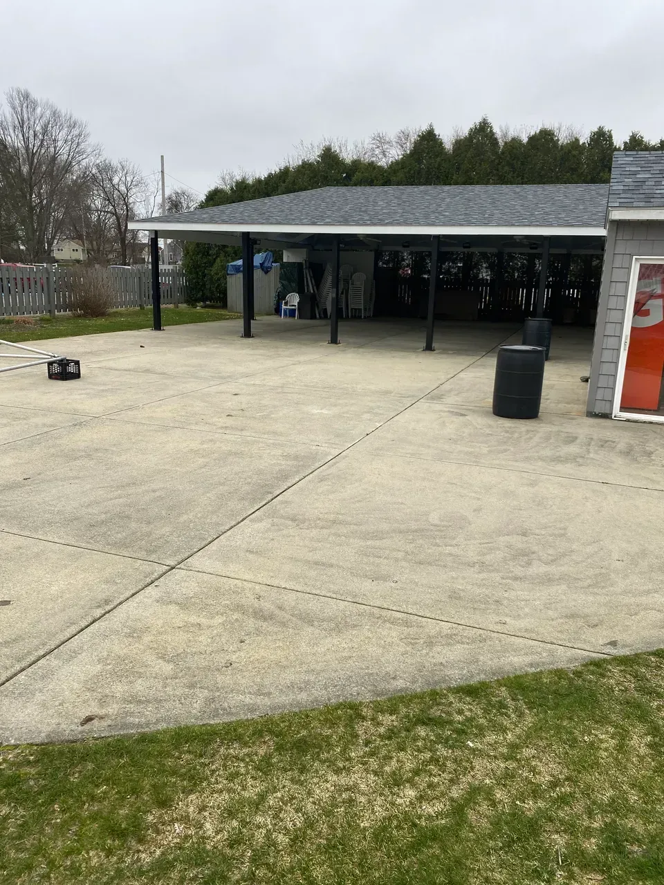 Concrete outdoor patio beside a covered pavilion on an overcast day