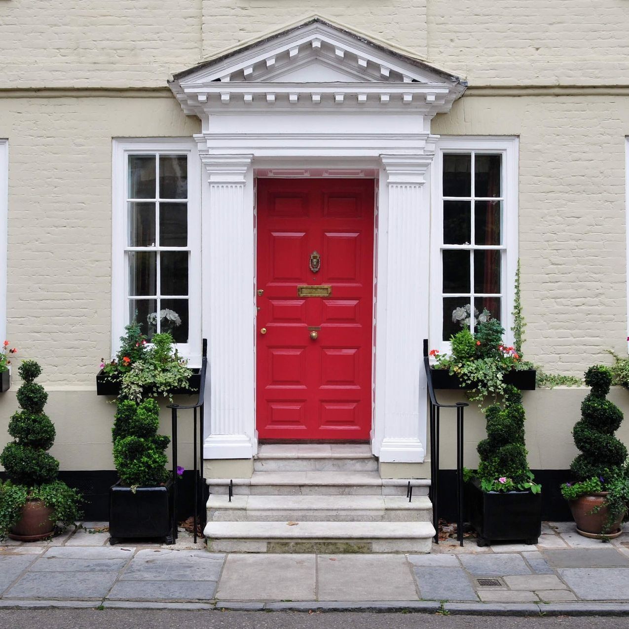 A house with a red door and white windows