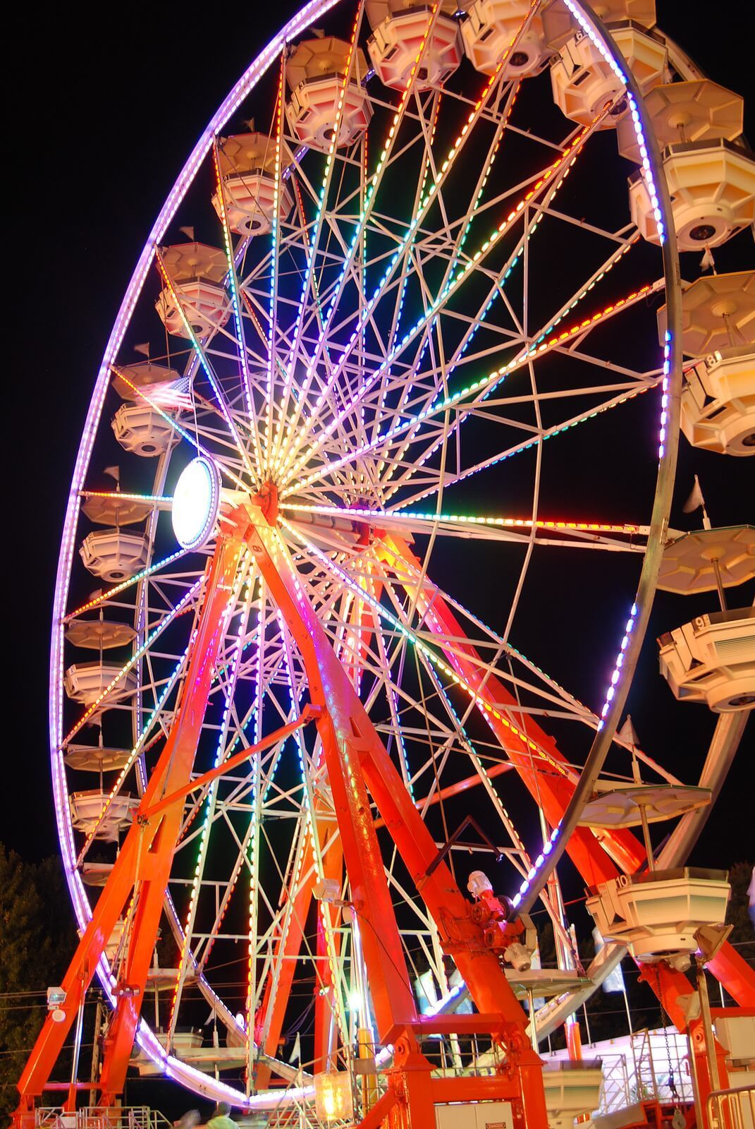 A rainbow colored Ferris wheel at night. Find pleasure that lasts in your relationship with Couples Retreats in Florida today. Our Couples Retreats are offered to couples throughout the United States.