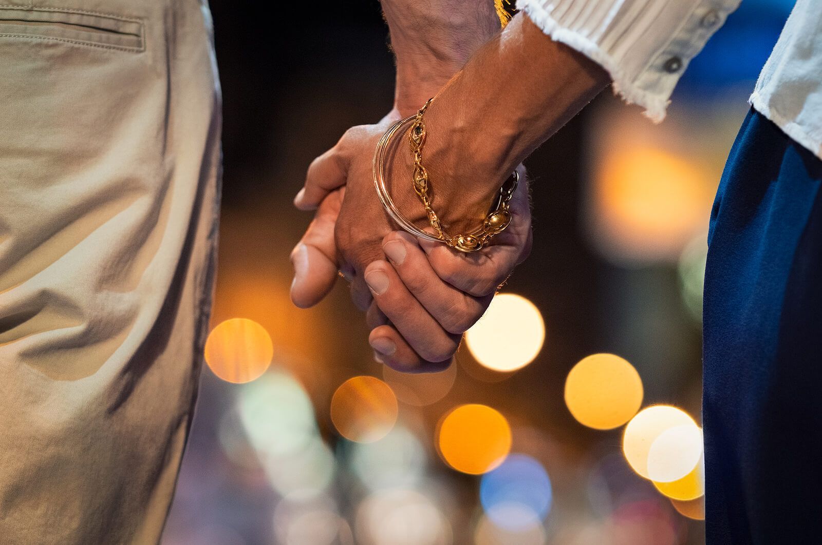 A couple holding hands after participating in a Hold Me Tight® workshop. A couples retreat in Orlando, FL can help you reconnect and strengthen your marriage therapy. Offered in Florida, Georgia, South Carolina, and beyond.