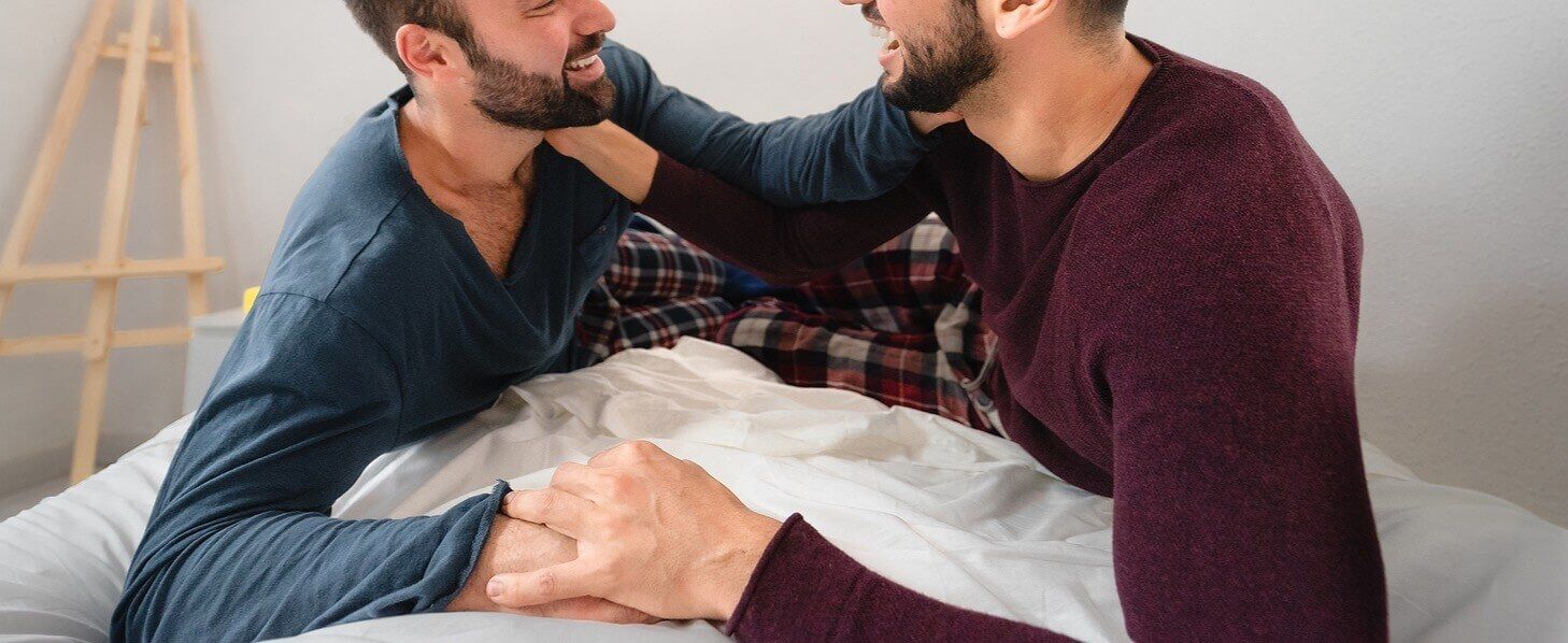 A gay couple laughing and working together to apply the skills learned in the Hold Me Tight® workshops presented by Couples Workshops of Florida. They serve couples in Florida, Georgia, North Carolina, South Carolina and beyond!
