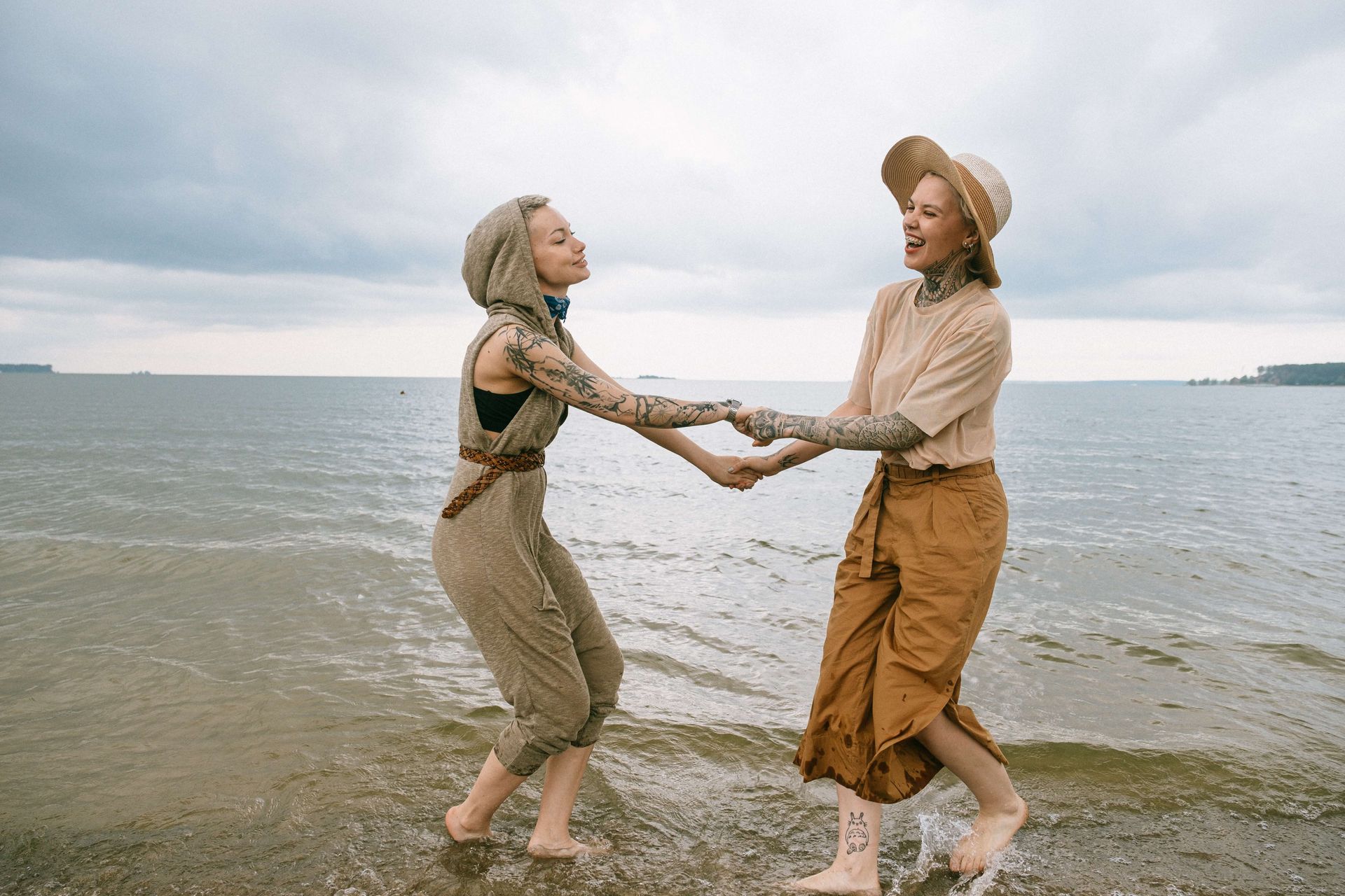 A happy couple splashes in the ocean. Gain happiness and connection with a Couples Retreat in Orlando, FL today. Retreats for Couples are available in Florida, South Carolina, Georgia, and beyond.