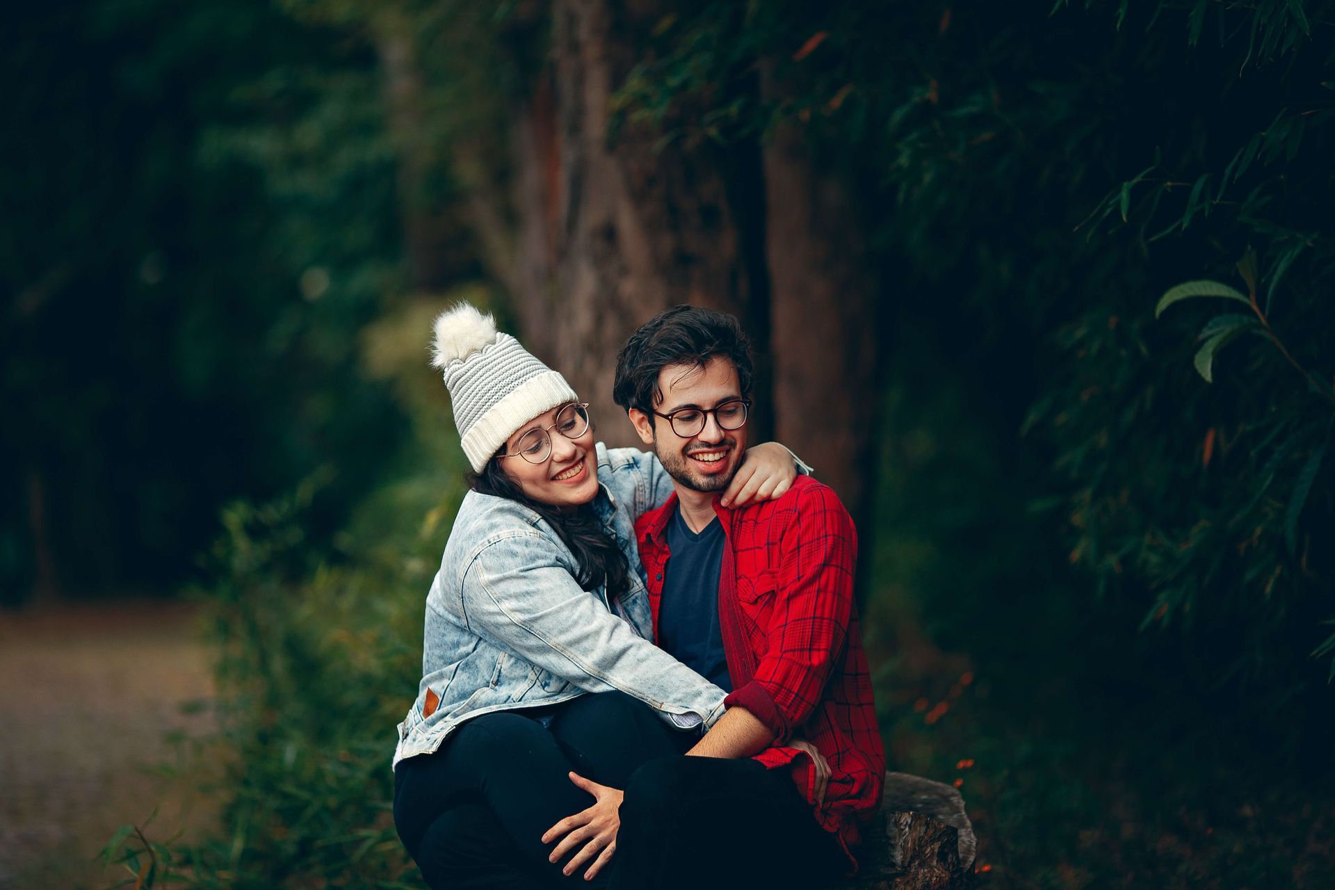 A couple sit together smiling and revitalized after attending a Hold Me Tight® Couples Retreat in Orlando, FL. Our Couples Retreats are available to couples in Florida and throughout the United States.