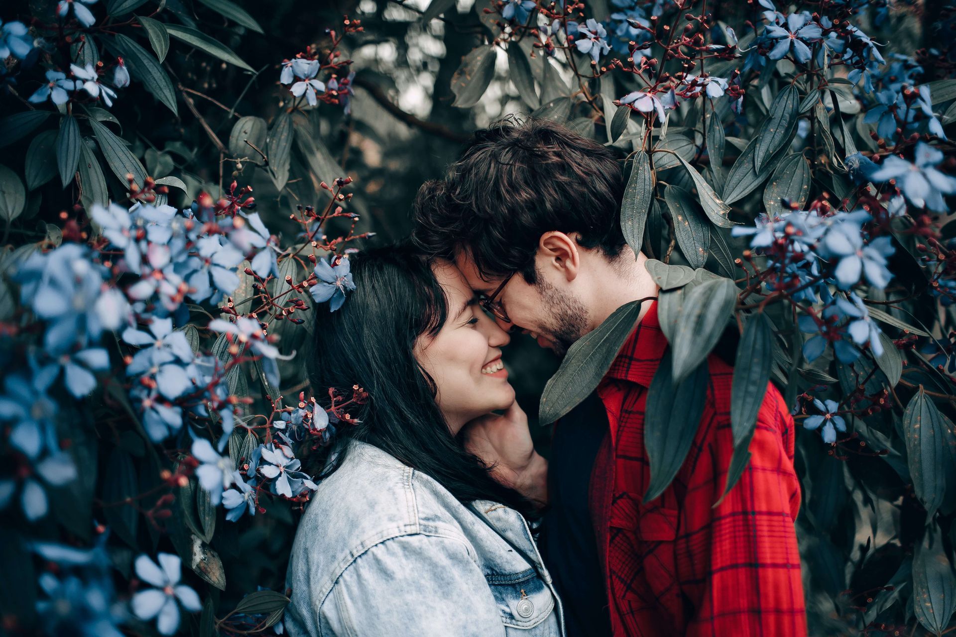 A couple shares an intimate moment surrounded by flowering trees. Create more moments like these with the help of a Hold Me Tight® Couples Retreat in Orlando. FL. Couples Retreats are available to anyone in the United States. Read on to learn more about Couples Retreats in Florida.