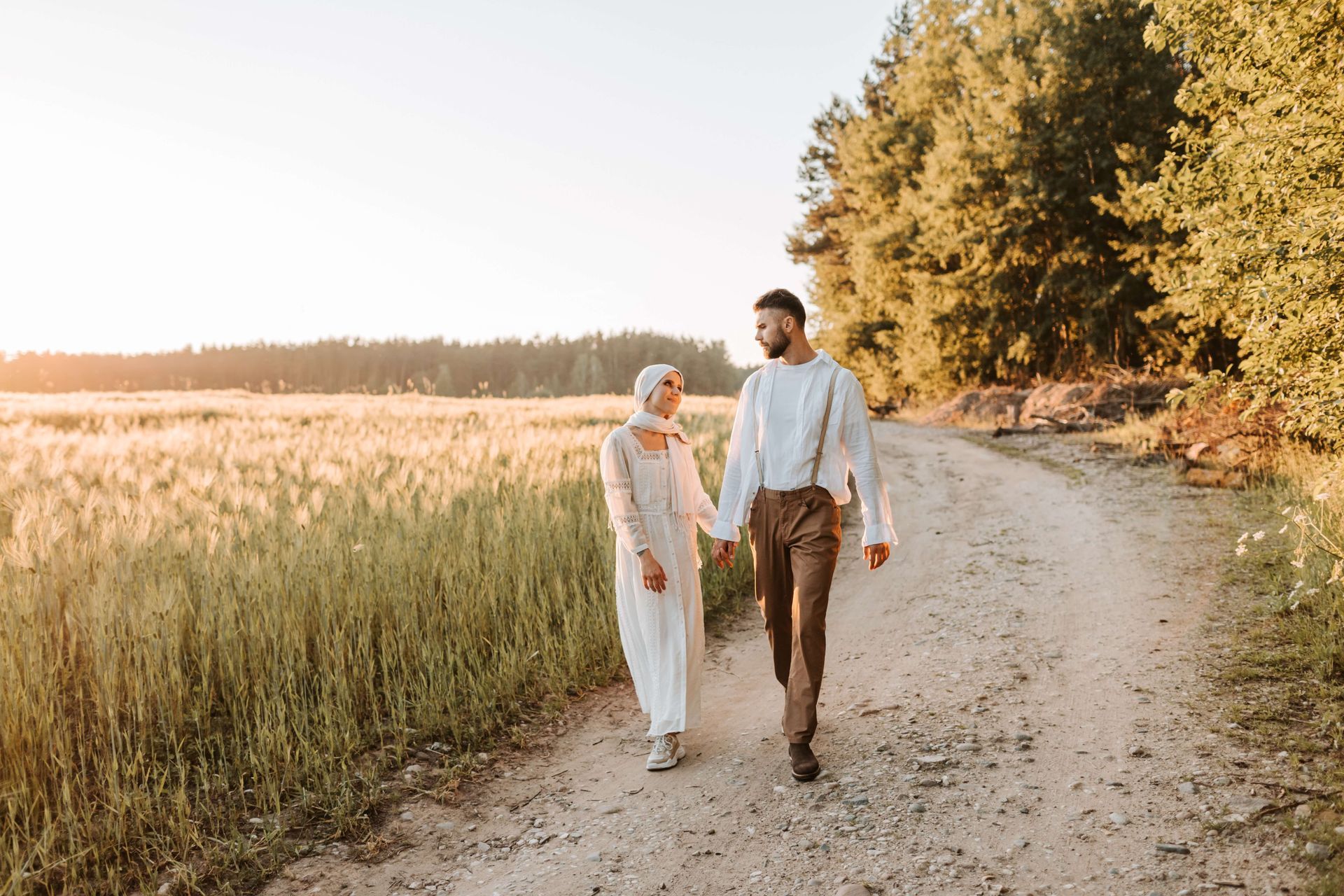 A couple walks hand in hand down a pathway. Reconnect with your partner on a deep and meaningful level with Hold Me Tight® Couples Retreats in Orlando, FL. Couples Retreats available to people in Orlando, Georgia, North Carolina and Nationwide.