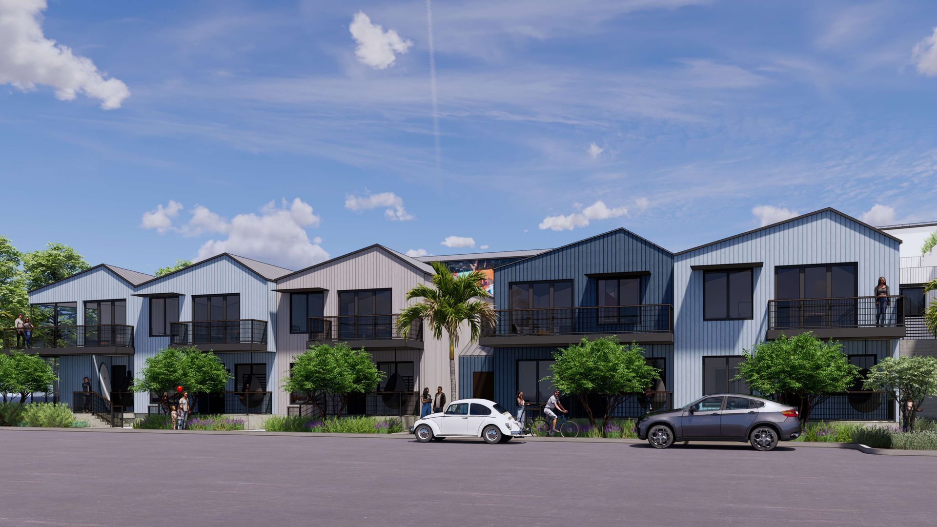 Row of modern townhouses with blue and gray siding, balconies, cars parked in front.