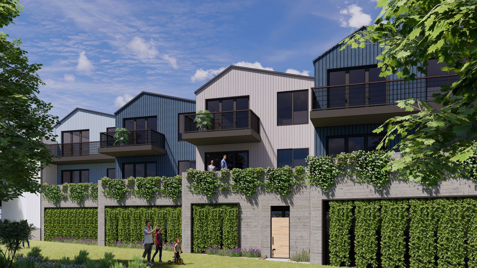 Row of modern townhouses with balconies, blue and white siding, above a concrete wall with greenery, people visible.