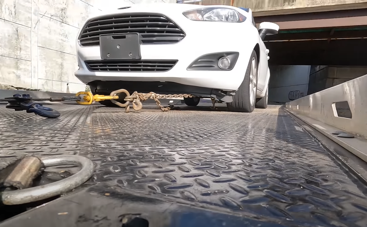 A white car on a flatbed tow truck in Mt Vernon, NY