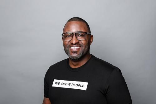 Man wearing glasses and a black t-shirt with