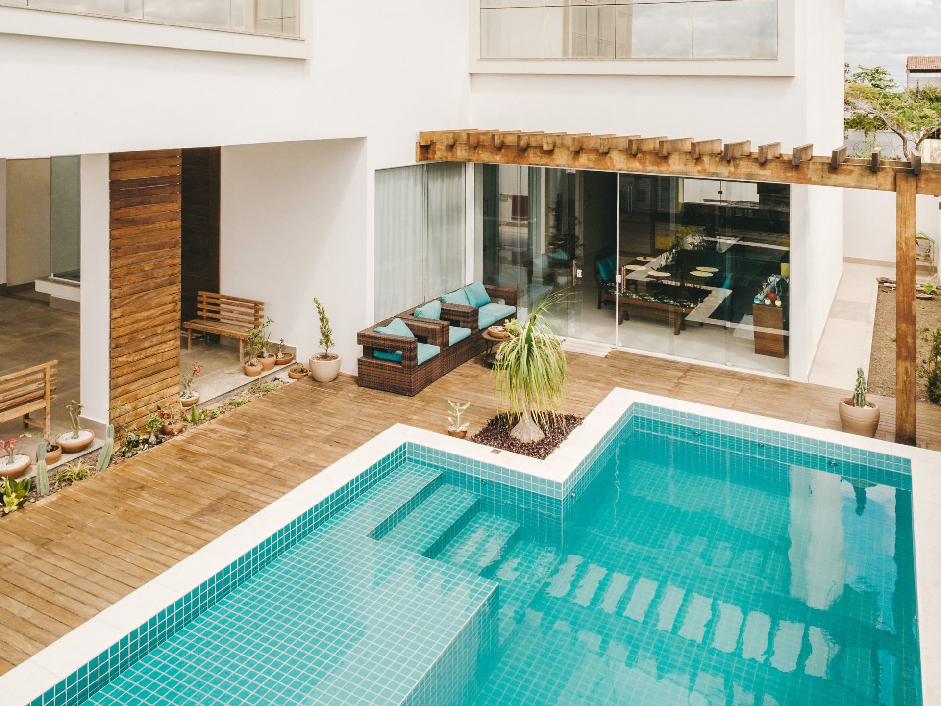 There is a large swimming pool in the middle of a house.
