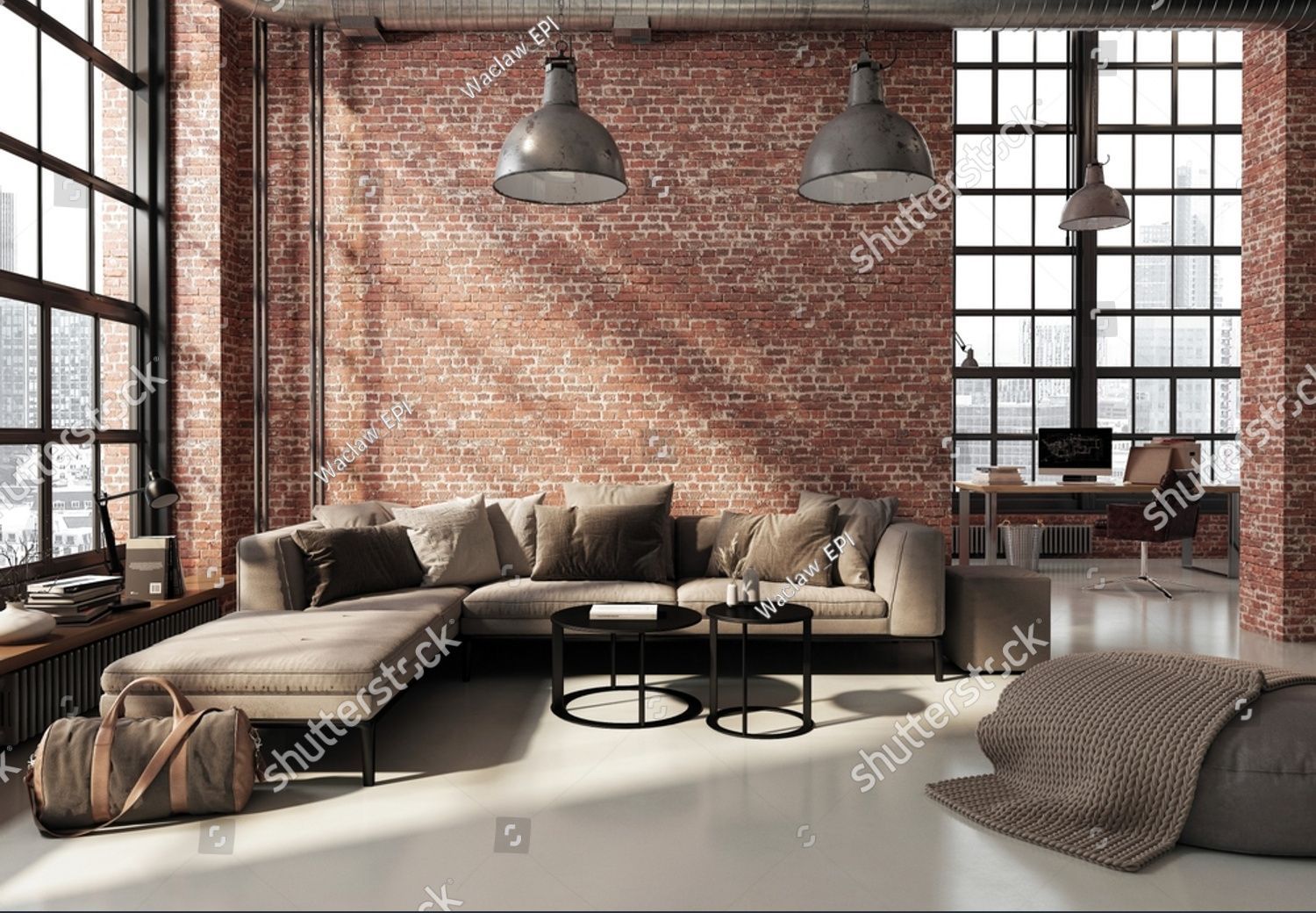 A living room with a couch and a brick wall.