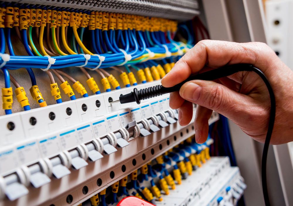 A Person is Working on an Electrical Box With a Pen — Gealy's Air-Conditioning, Refrigeration & Electrical in Nambour, QLD