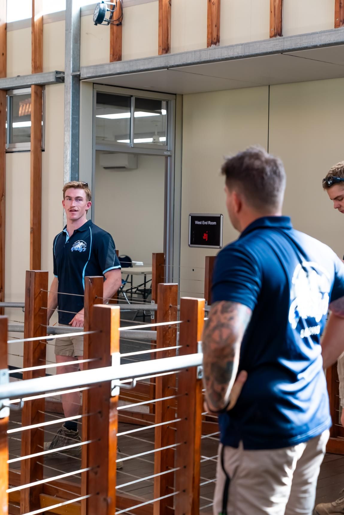 Close-up of a Silver Fan's Rotating Blades Behind a Protective Grill — Gealy's Air-Conditioning, Refrigeration & Electrical in Noosaville, QLD