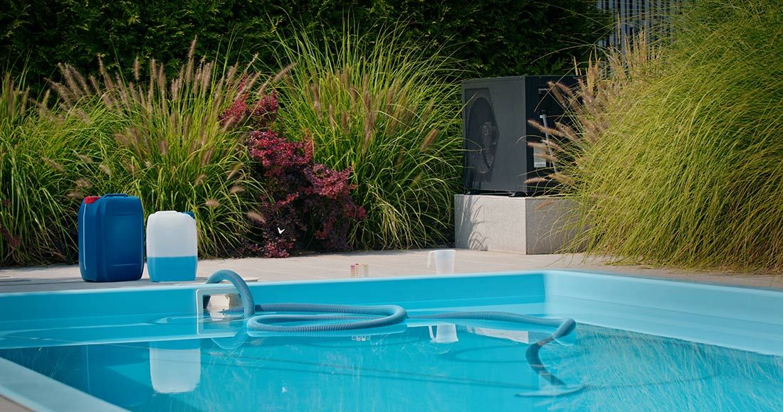 A Swimming Pool With a Hose and Chemicals in It — Gealy's Air-Conditioning, Refrigeration & Electrical in Maroochydore, QLD